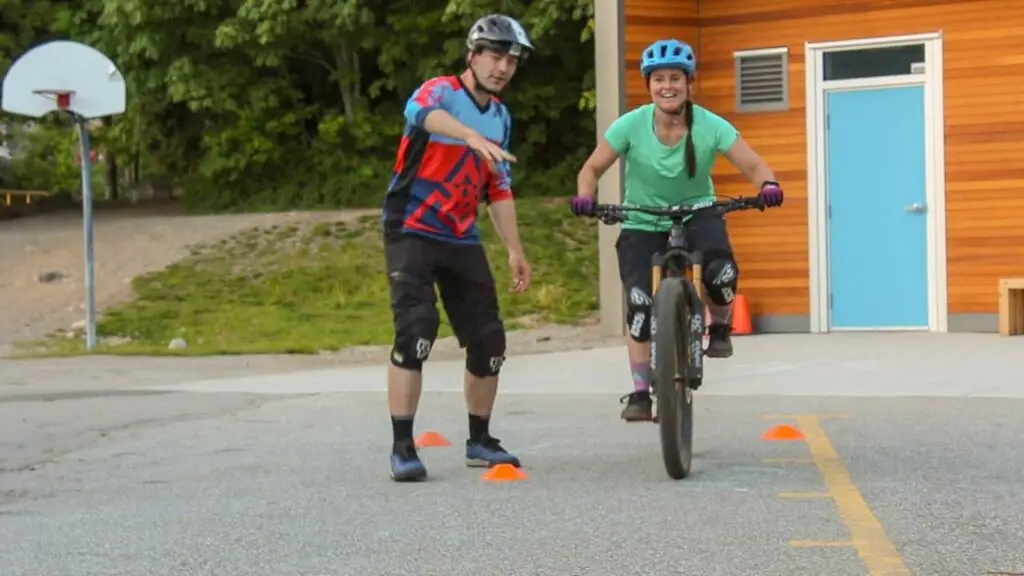 Women's Courses 3 Two people enjoying Squamish Mountain Biking in a parking lot.