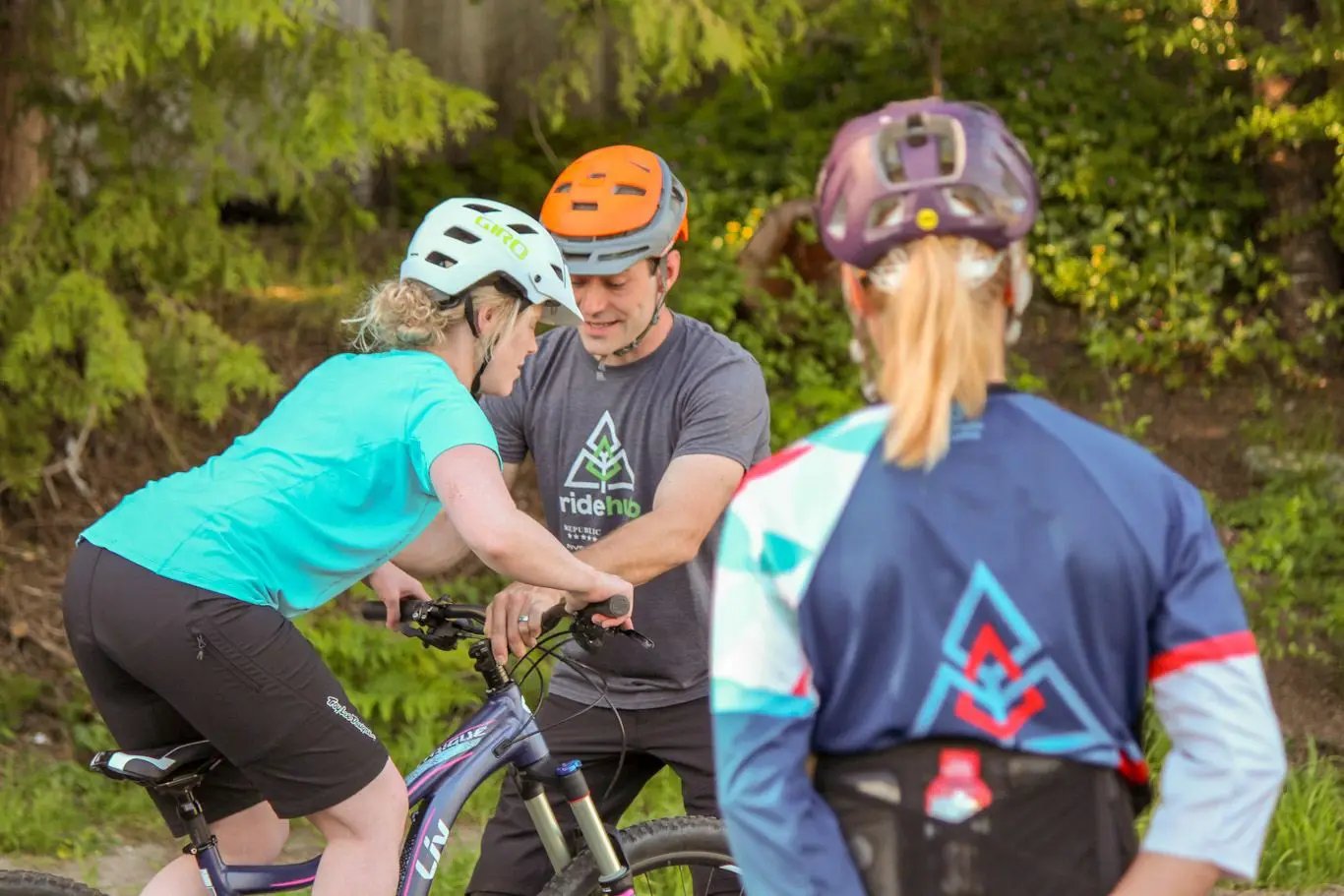 Women's Courses 1 A group of adventurous people riding bikes in the woods, fueled by coffee in Squamish.